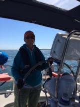 Jule at the helm of Sail Syzygy Jule at the helm of Sail Syzygy